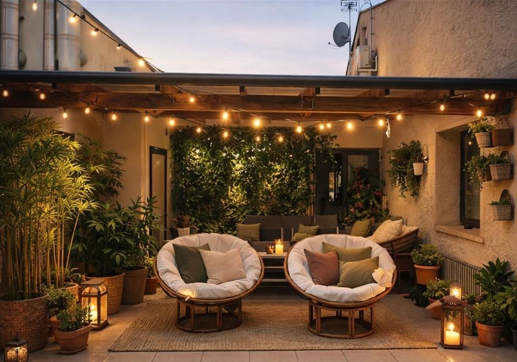 a patio with two chairs and a table with lights at WhiteHome in Conegliano