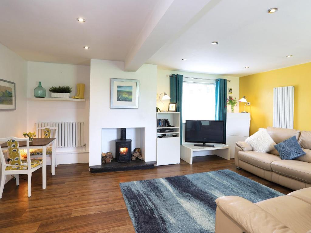 a living room with a couch and a fireplace at North Star Apartment - Uk3446 in Greenhaugh
