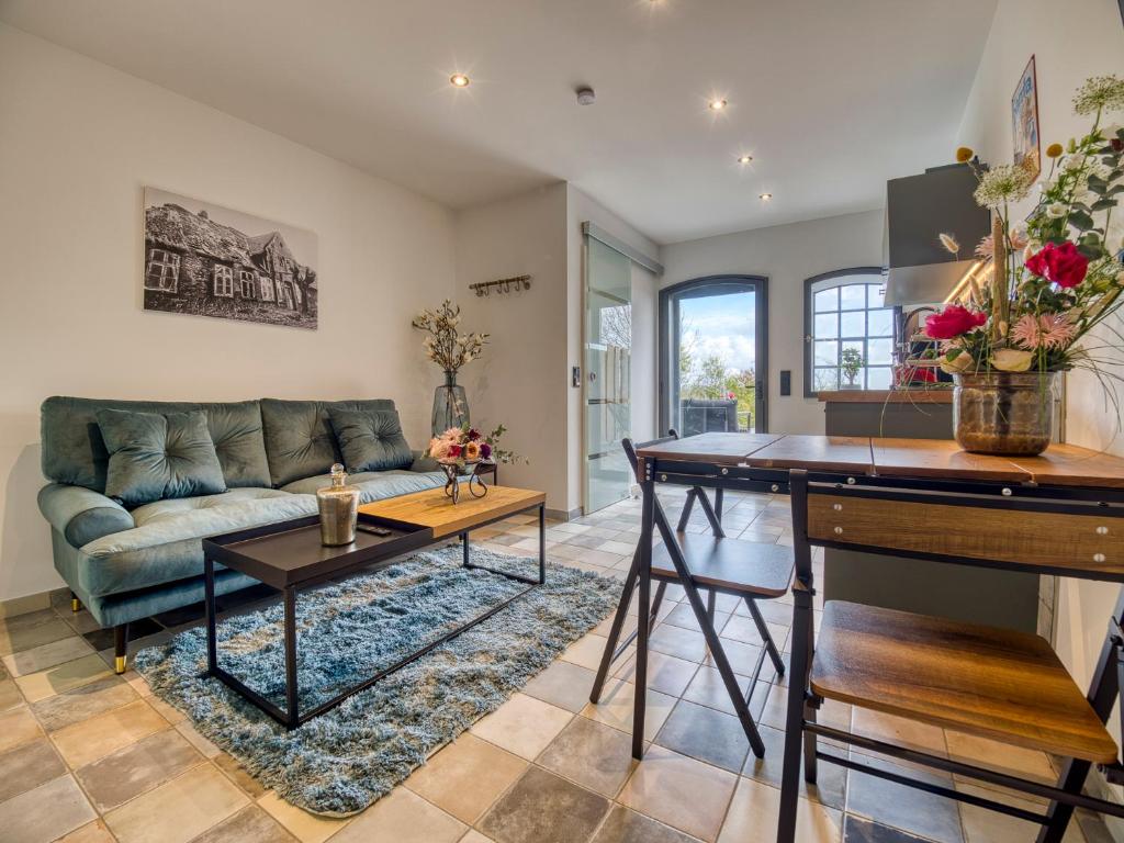 a living room with a couch and a table at Country Lodge - Stall in Tating