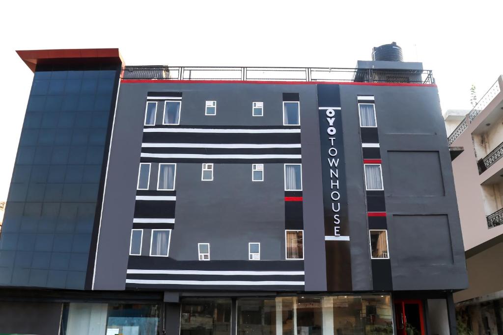 a building with a sign on the side of it at Townhouse Derawal Nagar in New Delhi