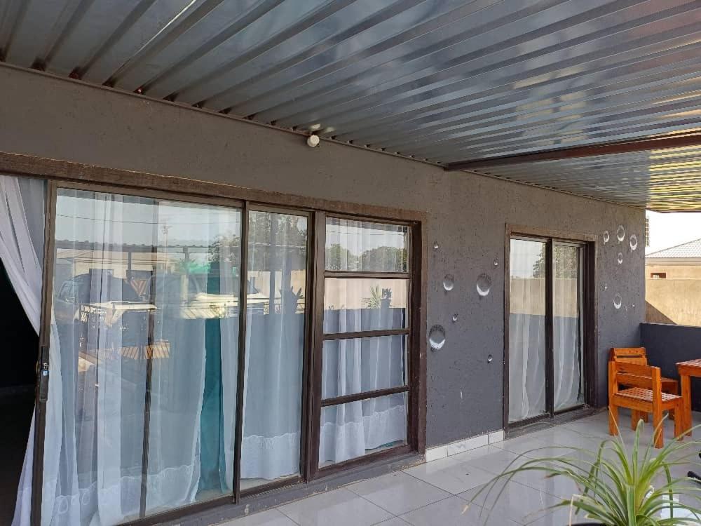 a patio with sliding glass doors and a metal ceiling at Yadah Accommodations in Lothlekane