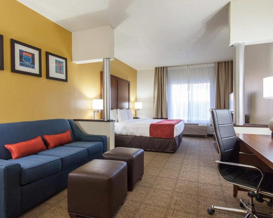 a hotel room with a bed and a couch at Comfort Suites Tulsa Central in Tulsa