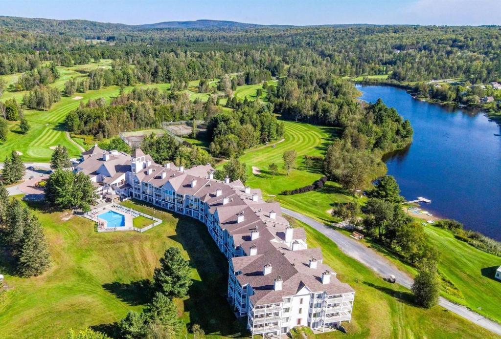 an aerial view of a resort with a lake at Manoir Des Sables, an Ascend Collection Hotel in Magog-Orford