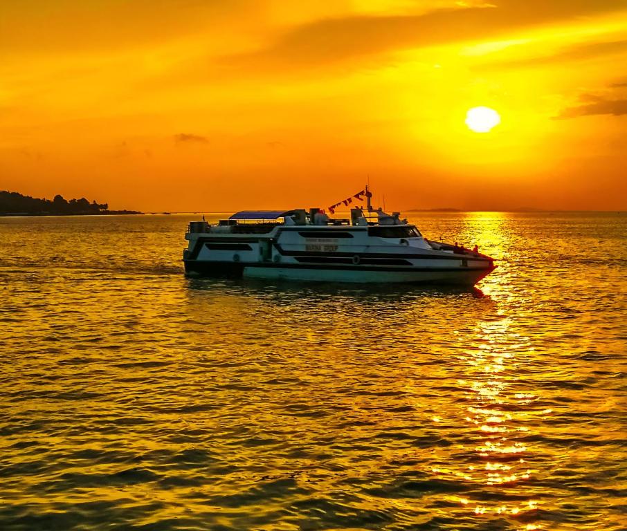 a boat on the water at sunset at GiliTicket fast ferries in Padangbai