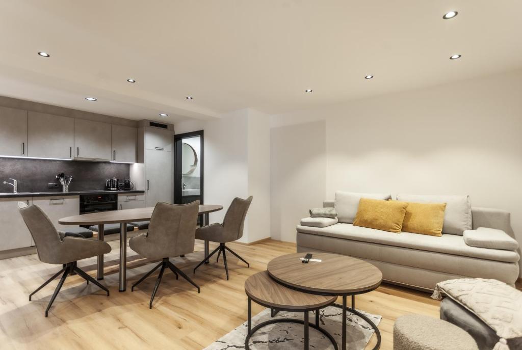a living room with a couch and a table at ötztalLOFT in Längenfeld