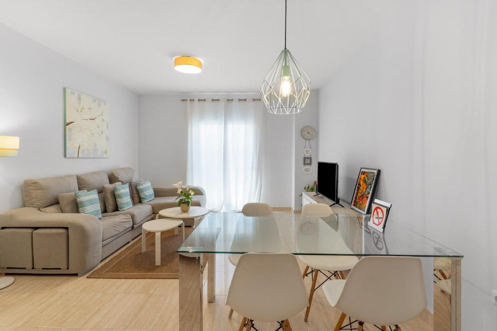 a living room with a glass table and a couch at Beach Center Only 150 M Luxury in Fuengirola