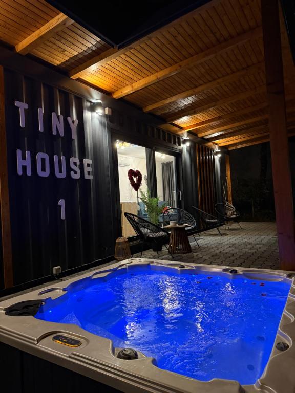 a large blue hot tub in the middle of a house at Tiny House by the forest 1 in Borod
