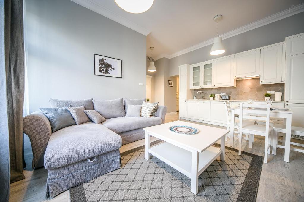 a living room with a couch and a table at Arianska Residence in Kraków