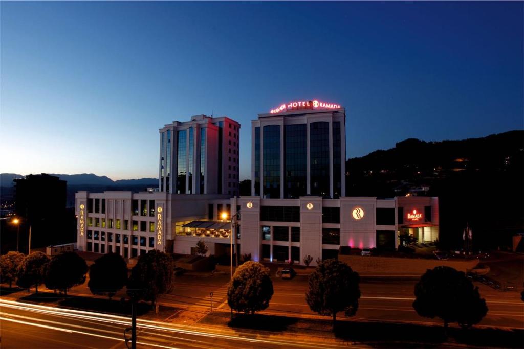 un edificio con un cartel encima por la noche en Ramada Plaza By Wyndham Kahramanmaras en Kahramanmaraş