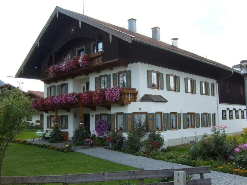 a large white building with flowers on it at Ruhlander-Hof in Unterwössen