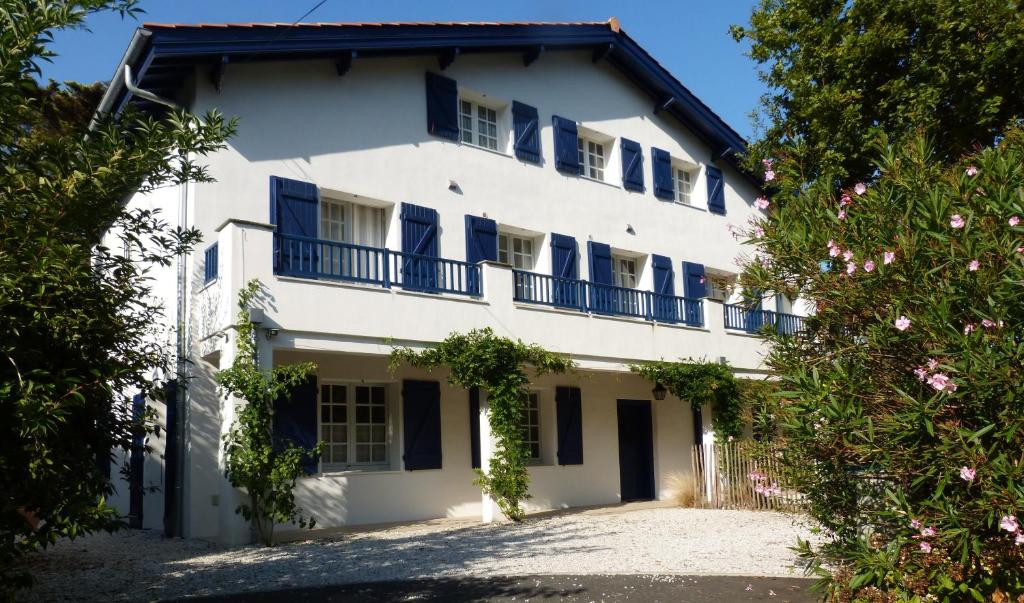 an exterior view of a white house with blue shutters at Dorre Pean in Ciboure