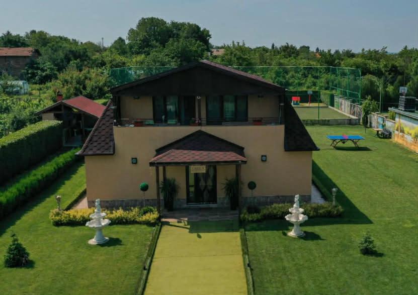 a house with a yard with two fountains at Erida Guest House - къща за гости до Русе in Trastenik