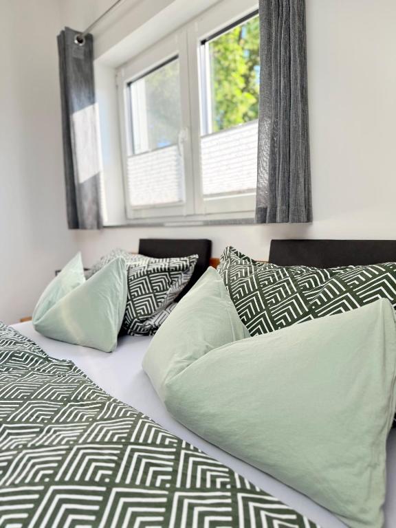 a bedroom with a bed with pillows and a window at Ferienwohnung-Karwe in Karwe