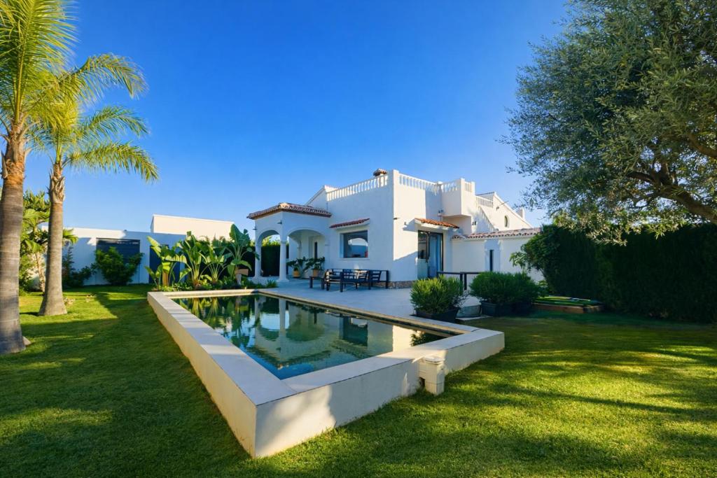 a white house with a swimming pool in a yard at Lo Exclusive Denia Els Poblets - Villa with private pool near to beach in Els Poblets