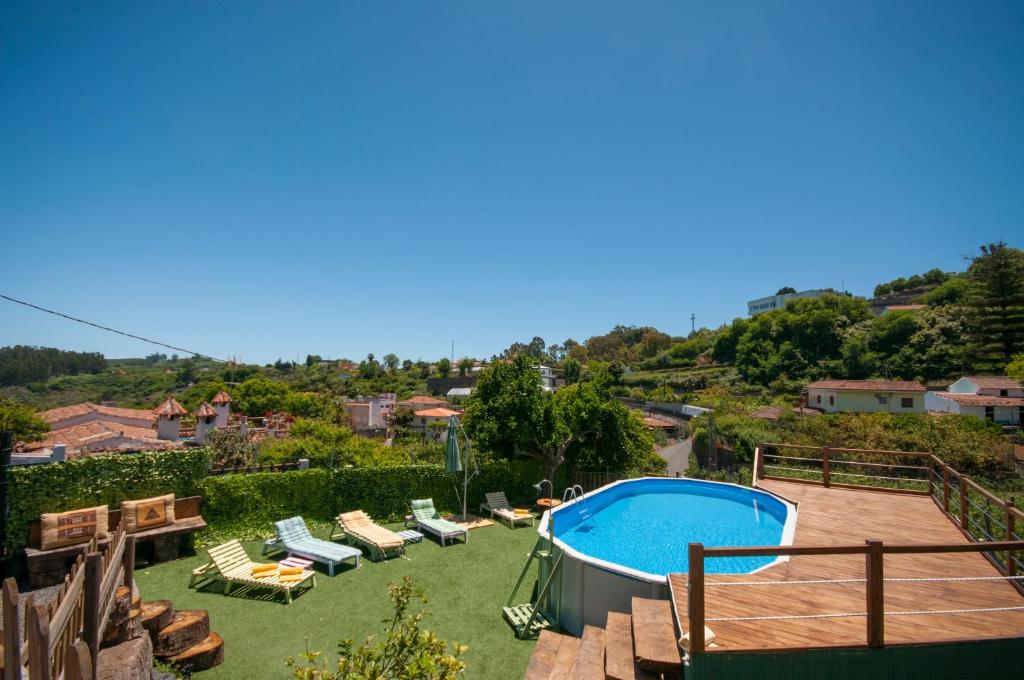 a backyard with a swimming pool and lounge chairs at Las Calas de Valleseco in Valleseco