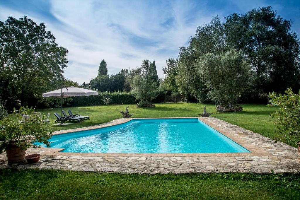 a swimming pool in the middle of a yard at La Casa Degli Elfi in Manziana