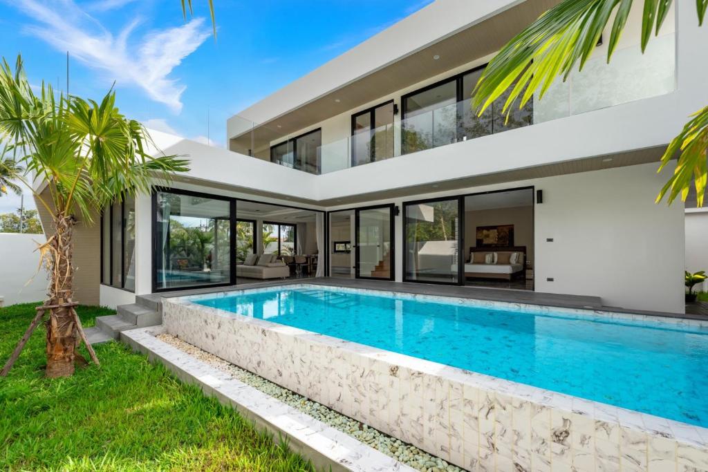 an exterior view of a house with a swimming pool at Dapple Villa in Na Mueang