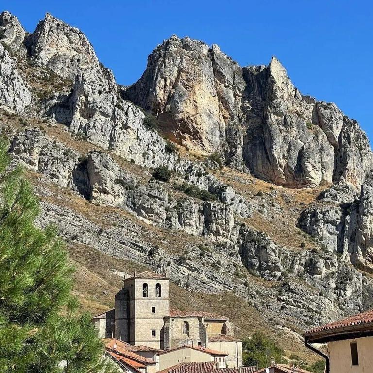 a church in front of a rocky mountain at Puentecuervo 3 in Pancorbo