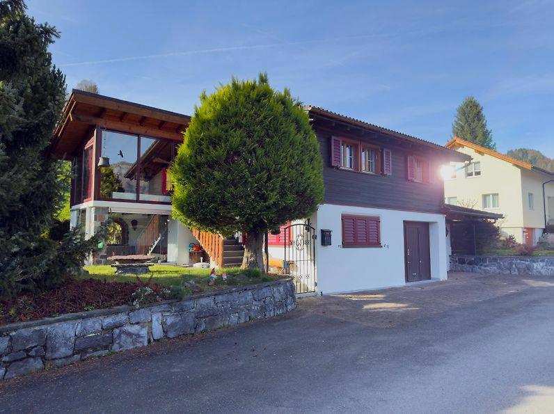 a house with a tree in front of it at Chalet Marguerite in Flums