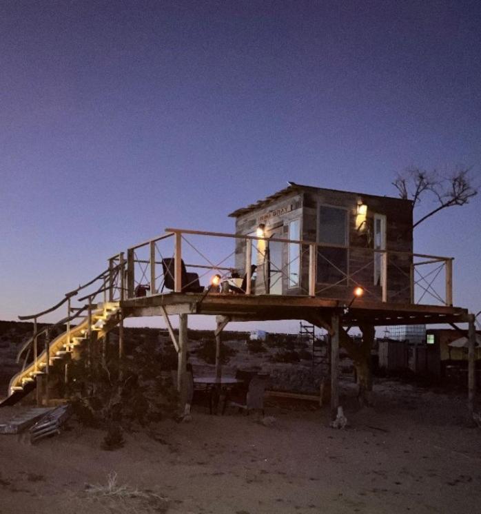 a tiny house sitting on top of a platform at Treehouse in Joshua Tree