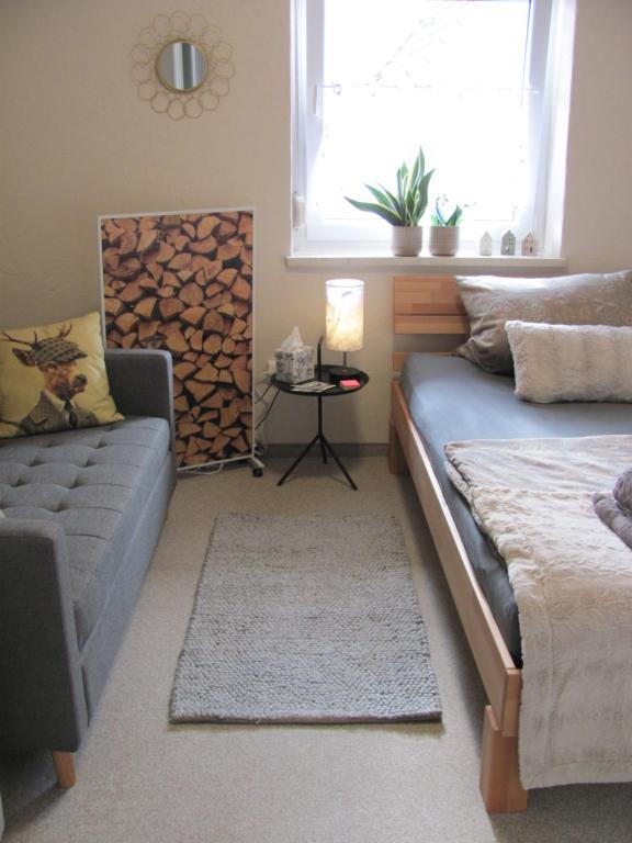 a bedroom with a bed and a couch and a window at #2 Komfortables großzügiges Gästezimmer mit Gemeinschaftsbad W-Lan Airport nah Late Night Check in Haus Nr 9,5 in Trunkelsberg