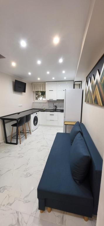 a living room with a blue couch and a table at B apartment Рахів in Rakhiv