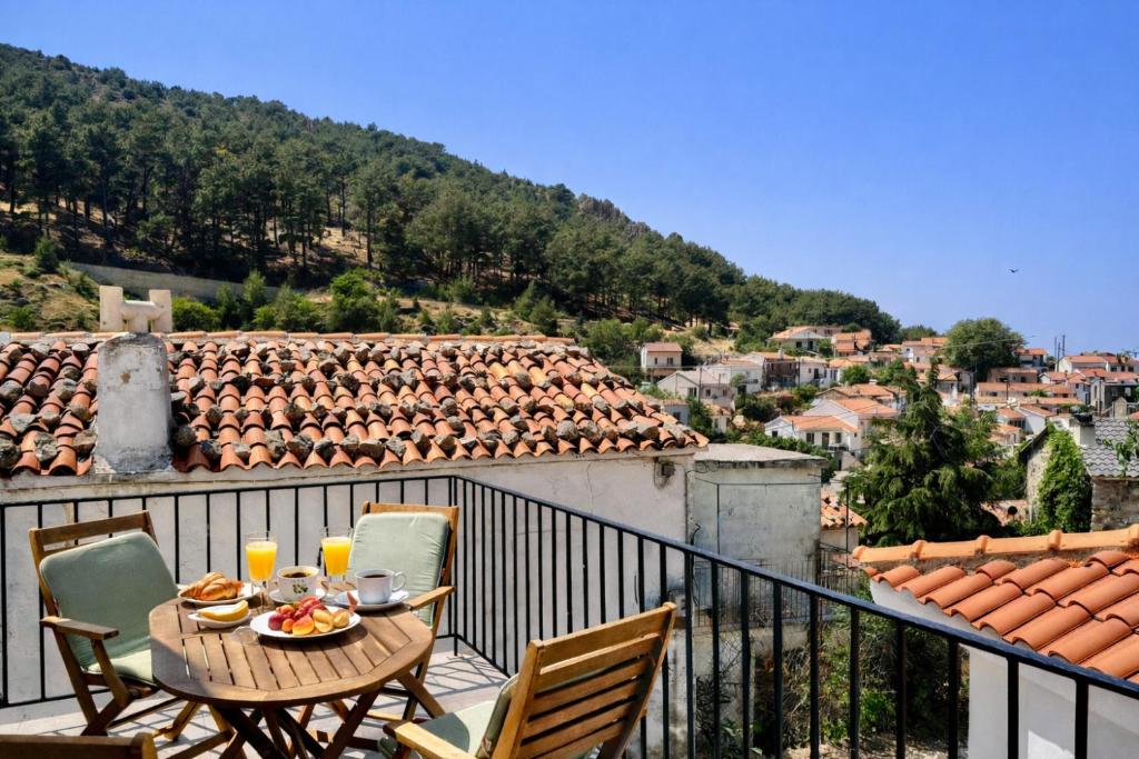 a table and chairs on a balcony with a view at Armonia Cosy Loft Chora Samothraki View in Samothraki