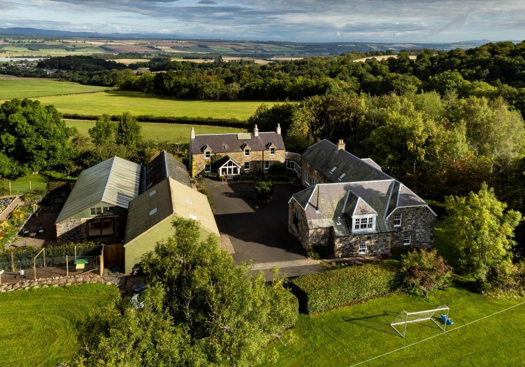 an aerial view of a large house in a field at The Studio at Pitmeadow Farm in Dunning