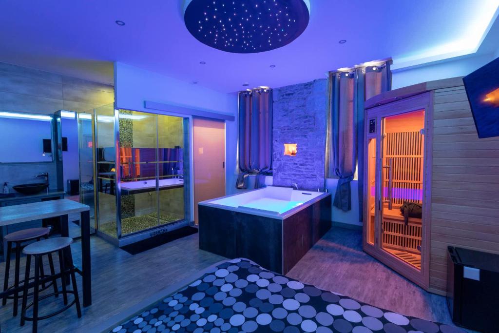 a bathroom with a tub and a sink and a shower at LX202 Love Room & Spa privatif - Jacuzzi & Sauna in Dijon