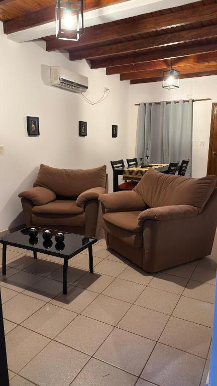 a living room with two couches and a table at Yvyrá Duplex in Eldorado
