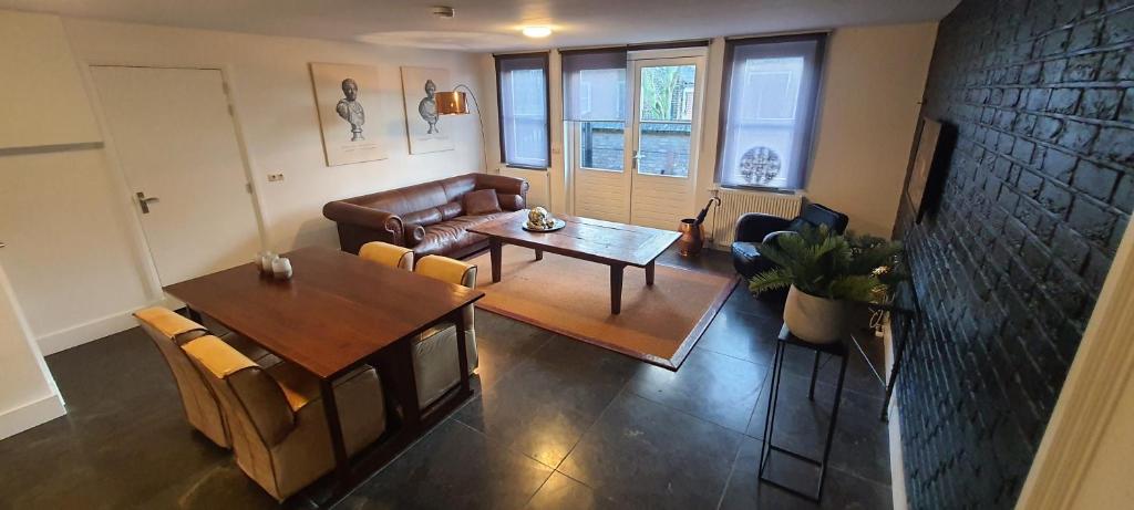 a living room with a couch and a table at B&B Velddriel in Velddriel