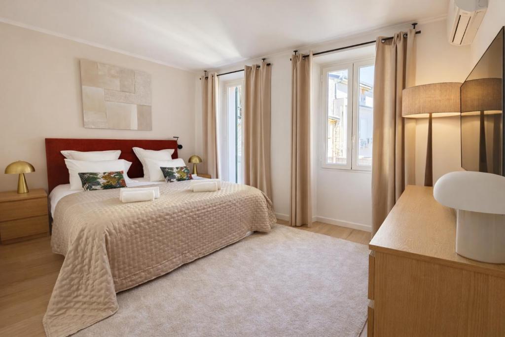 a bedroom with a large bed and a window at Luxury Elegance Comfort 3-room apartment of 80m2 with 2 BDR 2 BA 3 min Croisette & Beach in Cannes