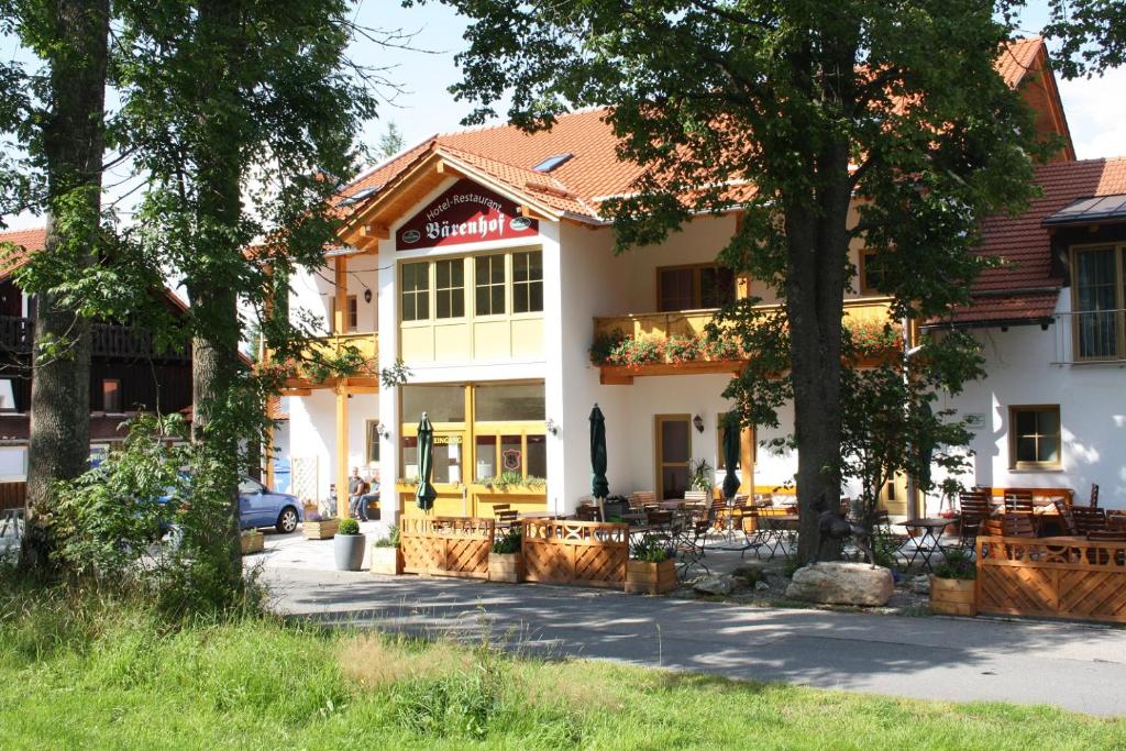a building with a cafe in front of it at Hotel Bärenhof in Philippsreut