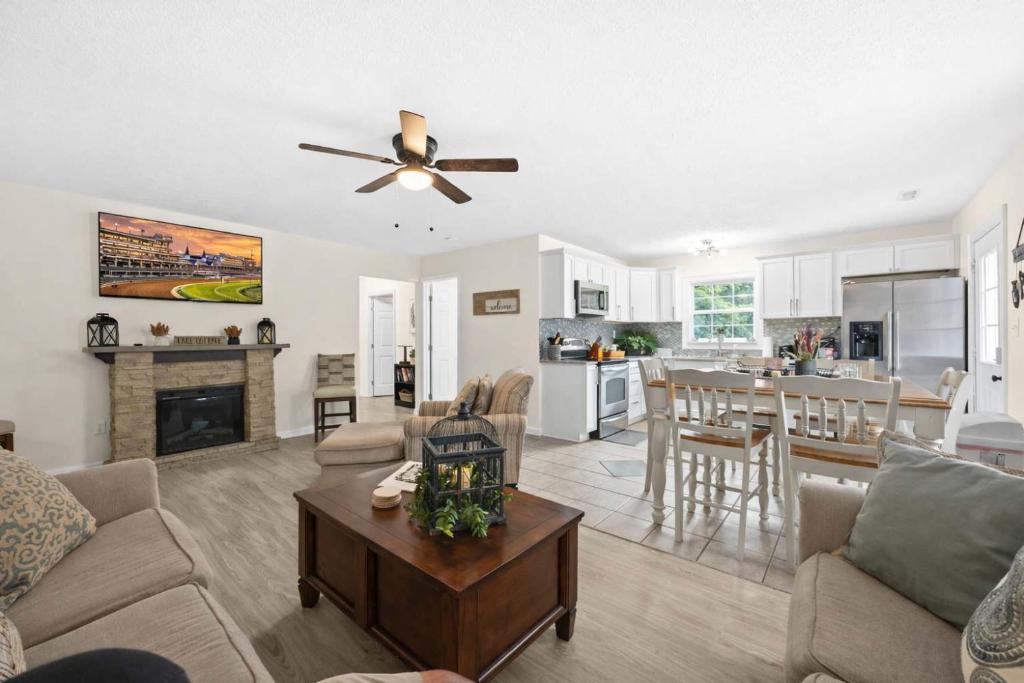 a living room with a ceiling fan and a kitchen at Rough River Lake Hideaway Your Lakeside Escape in Fentress McMahan