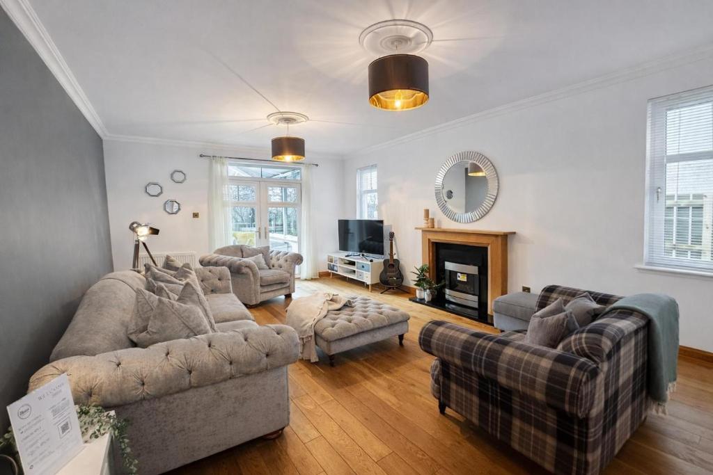 a large living room with couches and a fireplace at BraeView House in Inverness