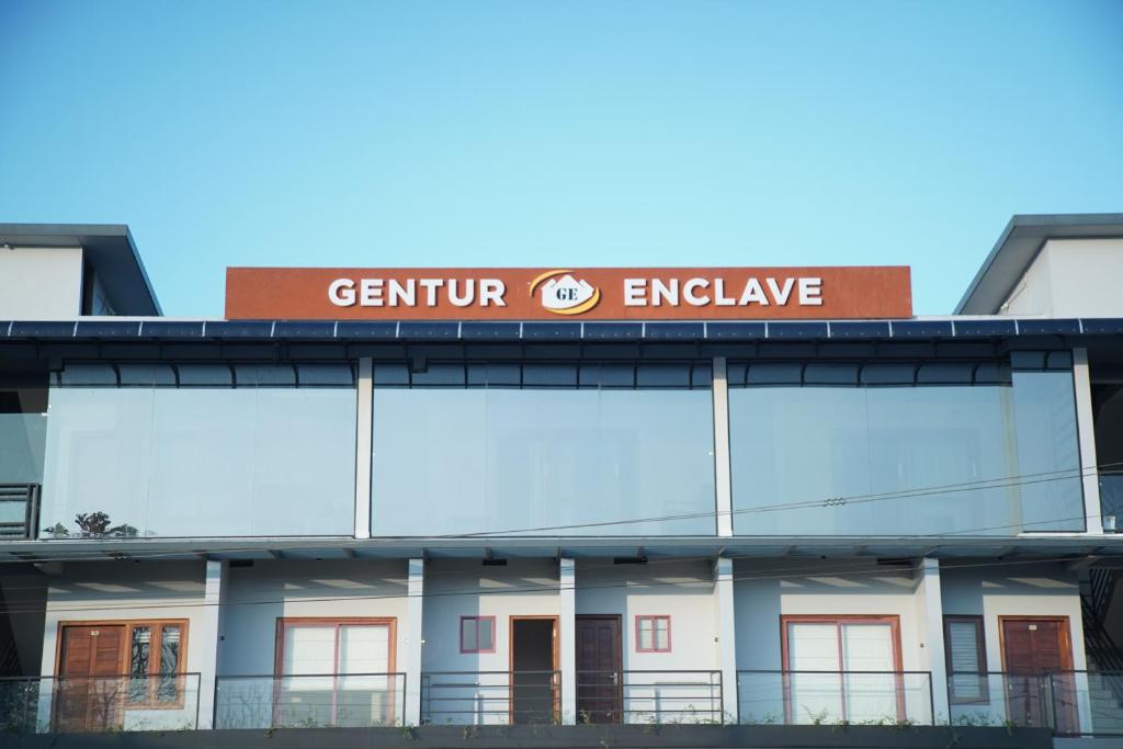 a building with a sign on top of it at Gentur Enclave in Mananthavady