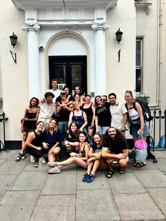 a group of people posing for a picture in front of a building at Urbany Hostel London 18-40 Years Old in London
