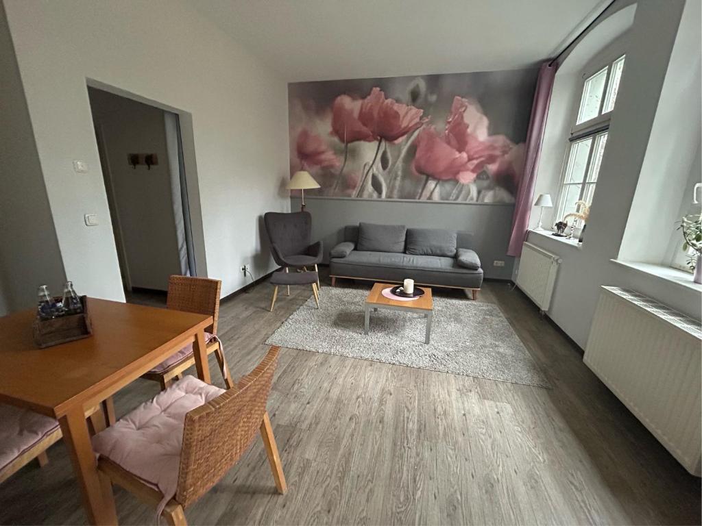 a living room with a couch and a table at Schloss Spiegelberg in Neustadt