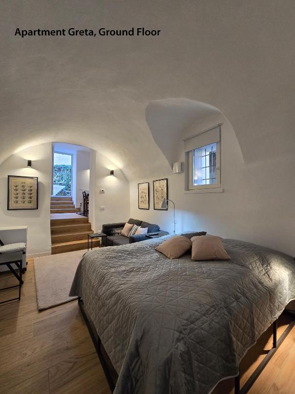 a bedroom with a bed and a living room at Casa Montebello in Bellagio