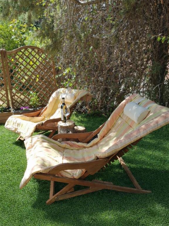 two lounge chairs and a table on the grass at La casa del Duero in Tordesillas