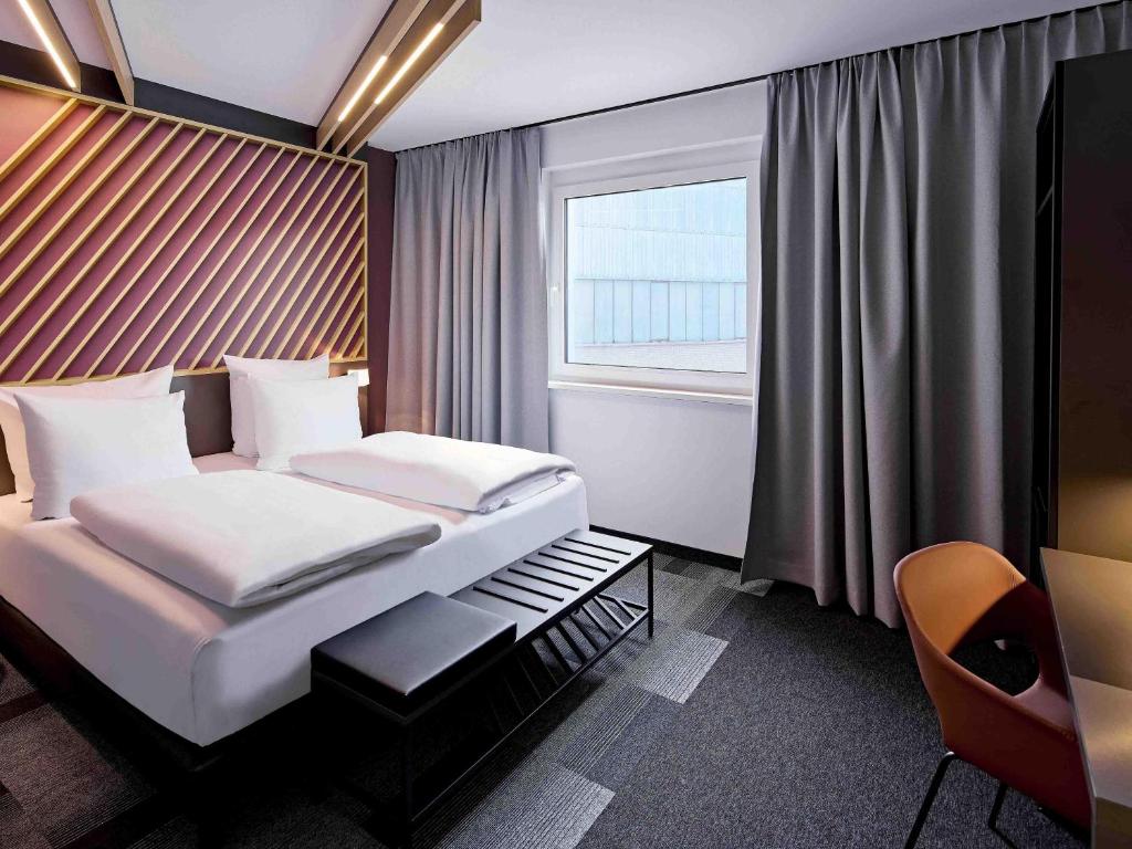 a hotel room with a bed and a window at B&B HOTEL Lippstadt in Lippstadt