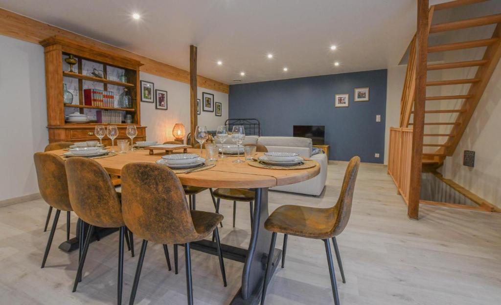 a dining room with a wooden table and chairs at Le charme du moulin in Beauvoir-sur-Sarce