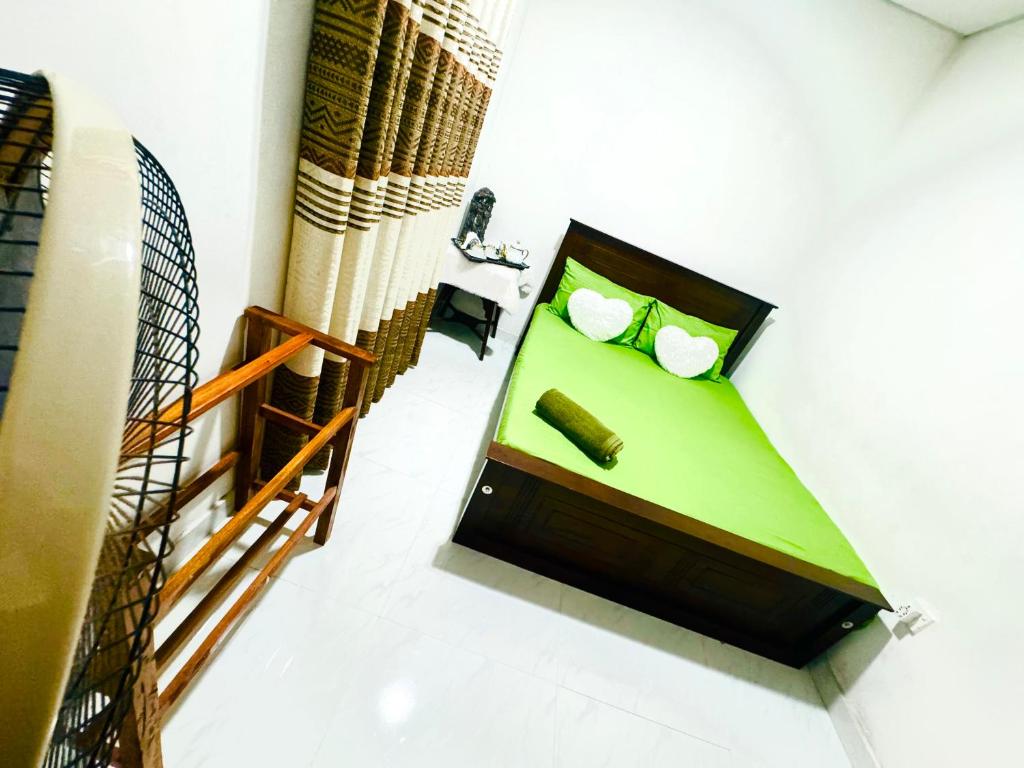 a room with a green table with two balls in it at D2 Holiday Inn in Badulla