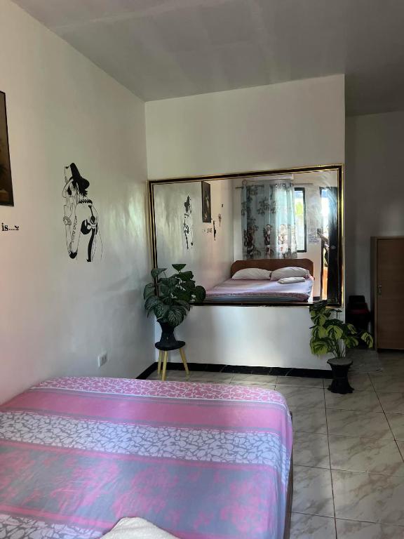 a bedroom with a bed and a large mirror at 88 Inn in Upper Katungal