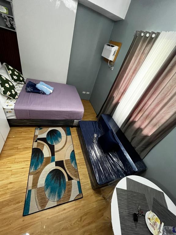 a small room with a bed and a rug at JAN Studio CDO Condo Stay in Lapasan