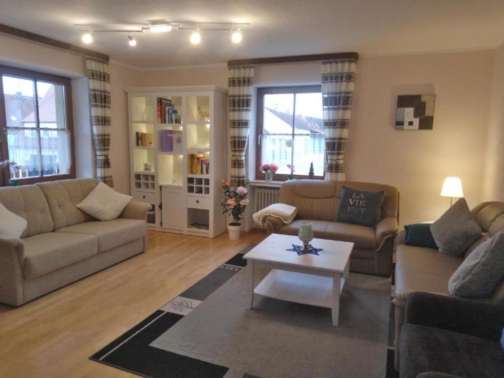 a living room with two couches and a coffee table at Im Haus am Ries in Ehingen am Ries