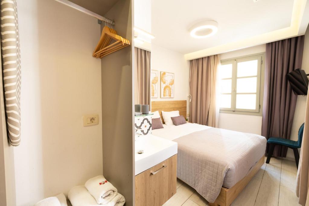 a hotel room with a bed and a sink at Cretan Berry Portou in Chania