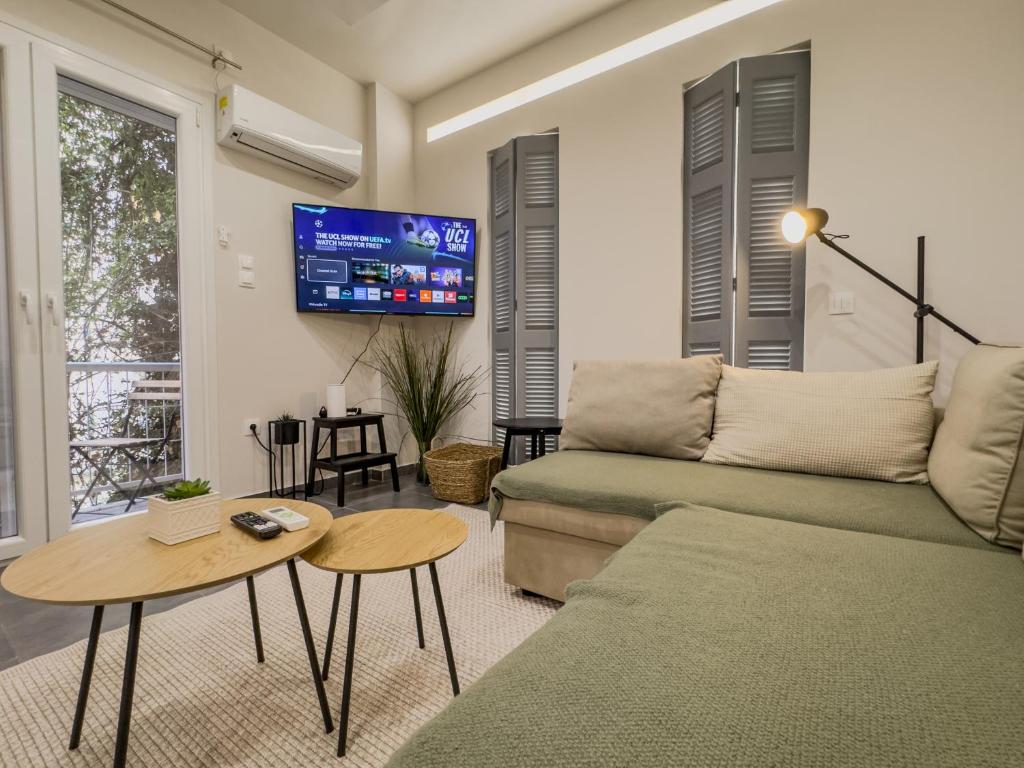 a living room with a couch and a table at Athenian Hideaway - Spa Tub and Walk to Metro in Athens