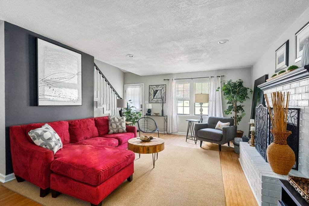 a living room with a red couch and a table at King 3bedroom, centrally located in Augusta