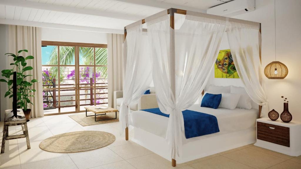 a bedroom with a bed with a canopy at Luxury Resort e Hotel Ltda in Jericoacoara